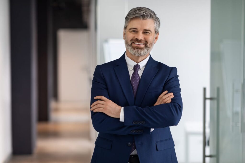 A personal injury attorney with his arms crossed and smiling in Miami.