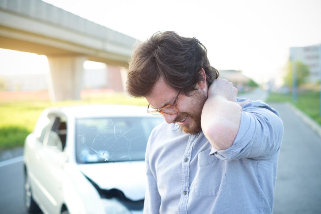 Man feeling pain to the neck after car crash