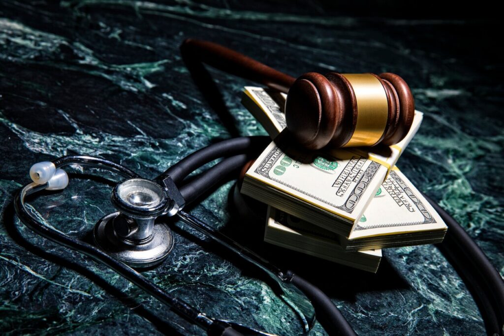 gavel with stethoscope and money
