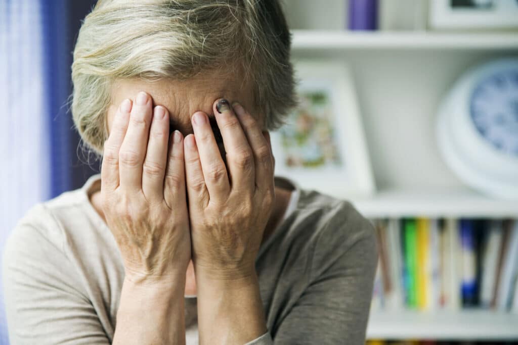 elderly woman grieving