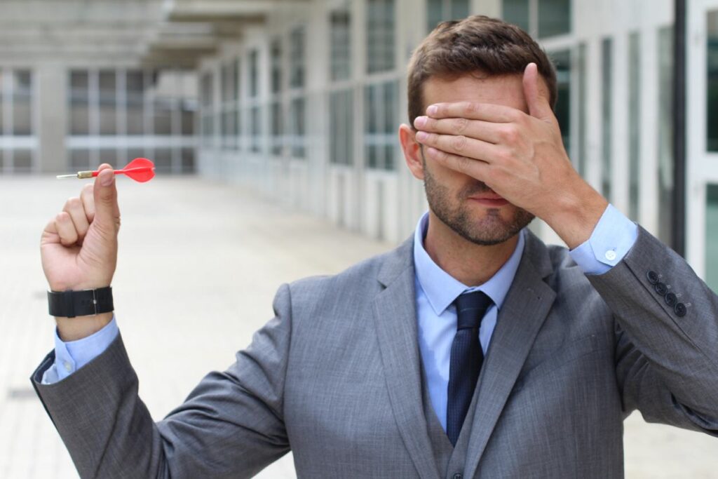 Blind businessman holding a dart