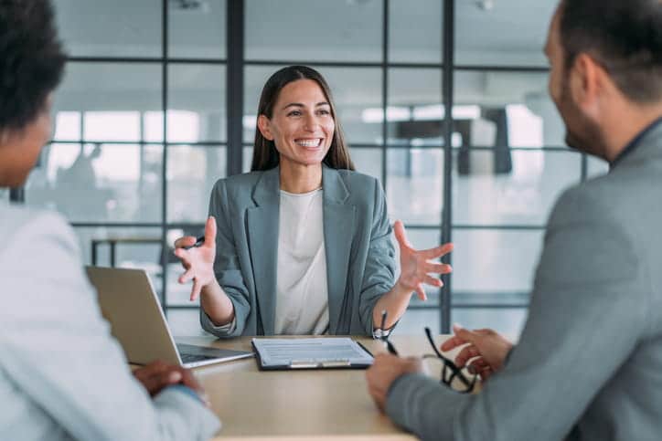 A Personal Injury Lawyer Smiling With Two Of Her Clients. 