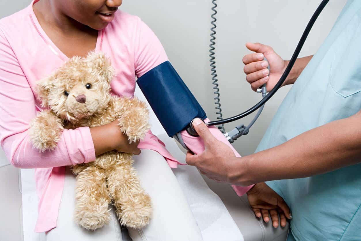 child with blood pressure cuff