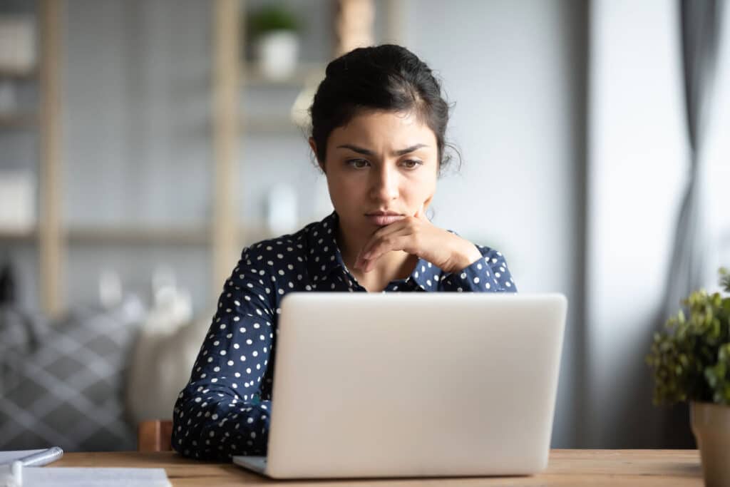 woman searching online database on laptop