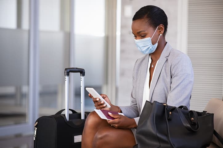 Woman wearing mask while traveling for business