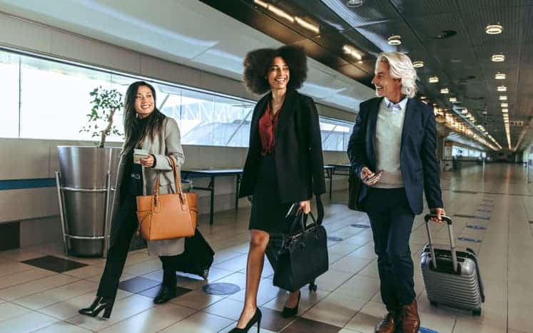 Professionals on business trip walking with luggage