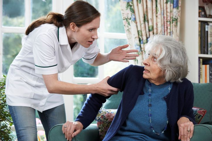 Care Worker Mistreating Senior Woman At Nursing Home