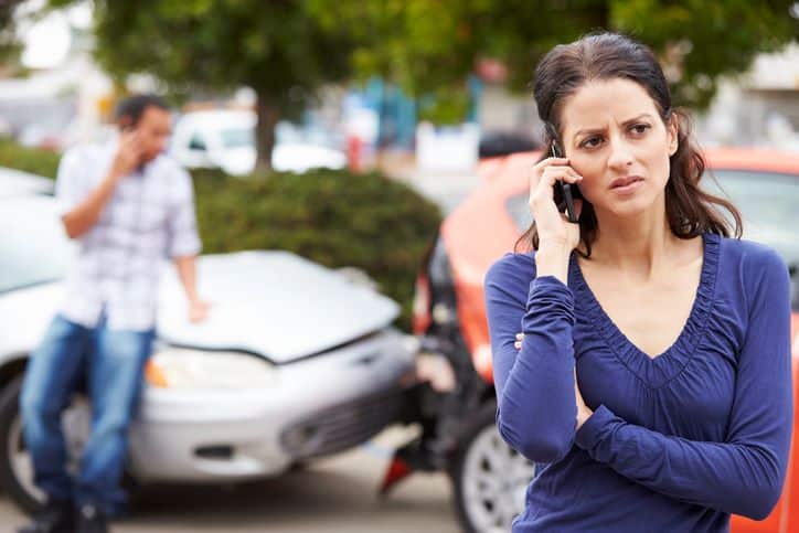 Female Driver calling insurance company After Car Accident