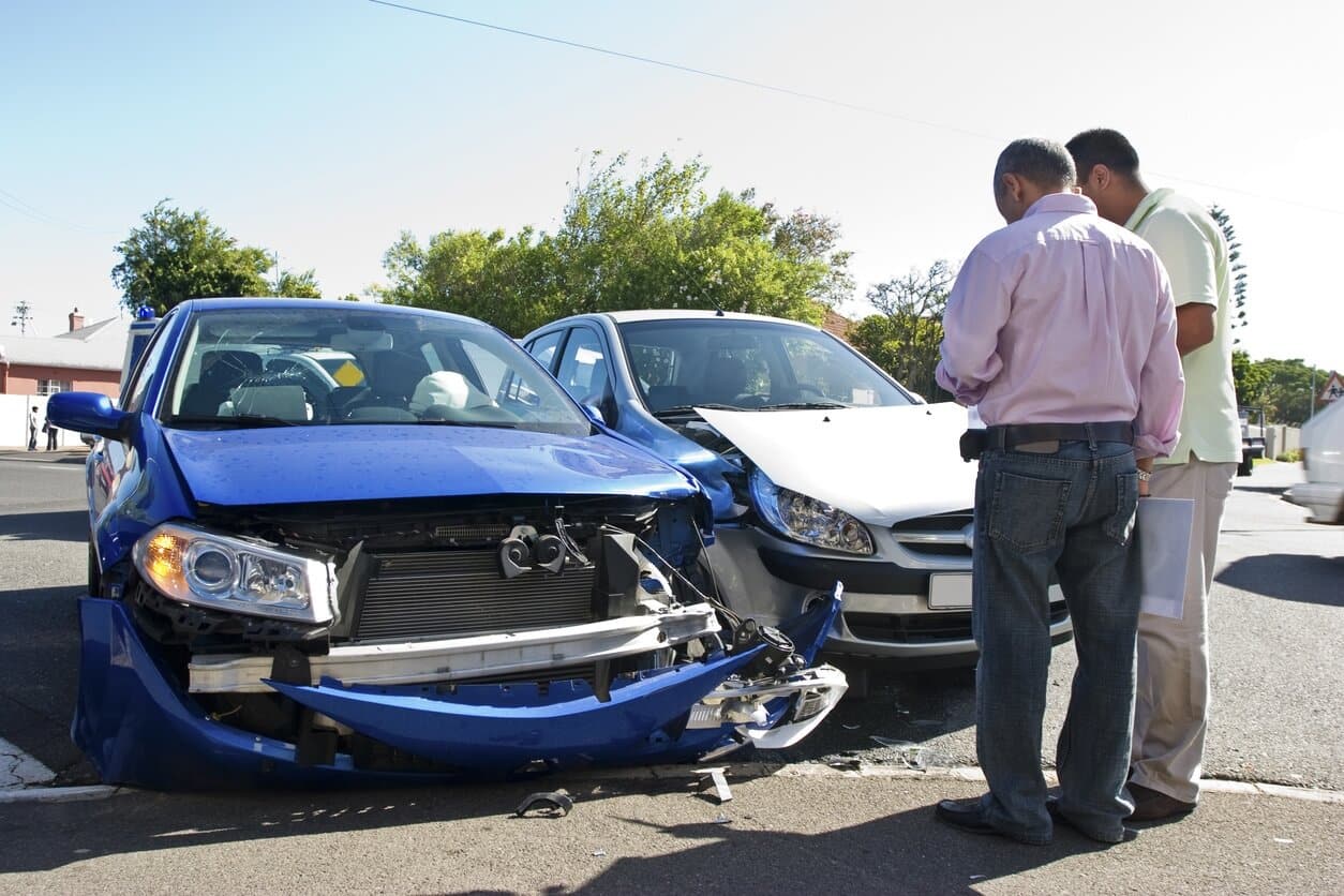 two men talking near car accident
