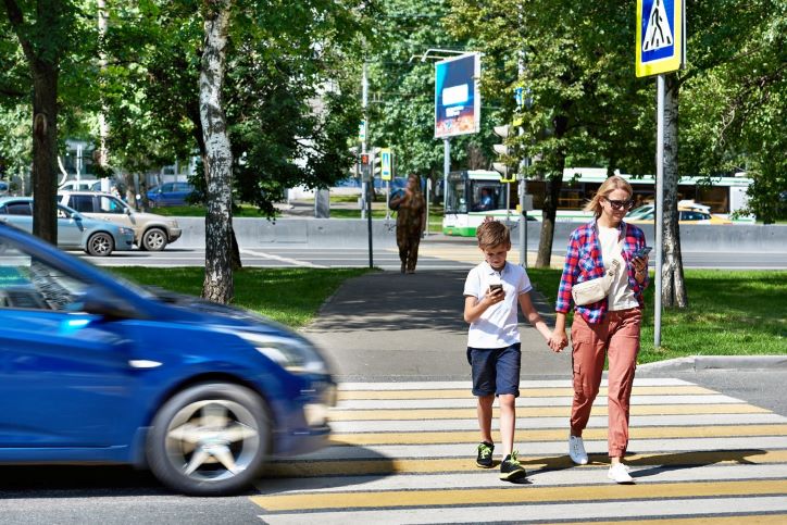 mother and son crossing the street about to get hit by a passenger car