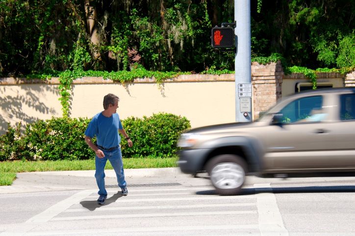 Pedestrian About To Be Hit By A Pickup Truck While Crossing The Street