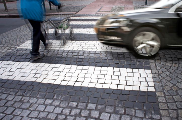 pedestrian with a walker about to get hit by a speeding car
