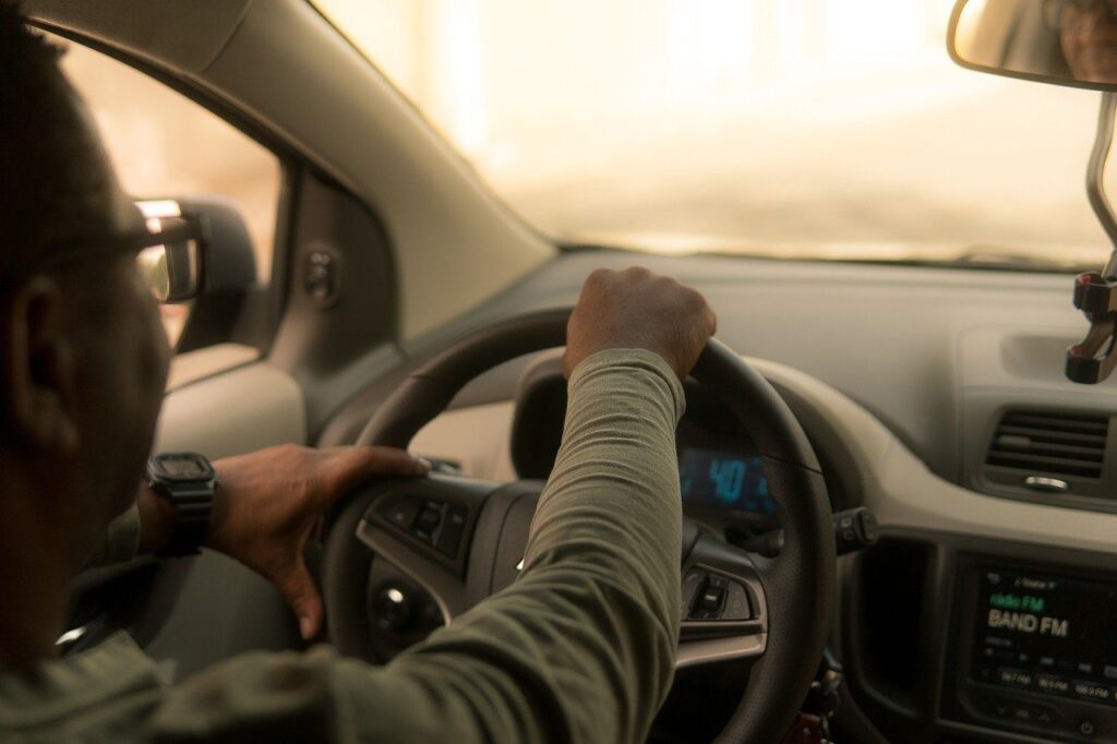 Man driving behind the wheel of a car