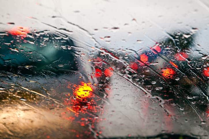 view of traffic through windshield in the rain