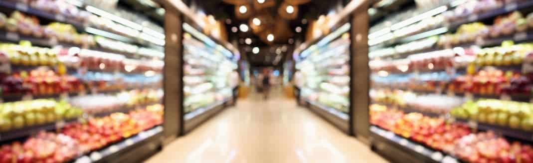 Grocery store shelves with fruits and vegetables blurred background