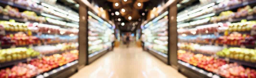 Grocery store shelves with fruits and vegetables blurred background 