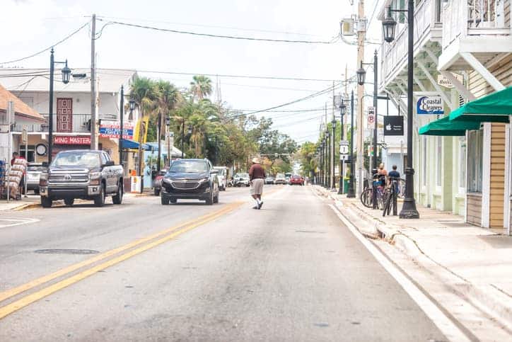 Pedestrian jaywalking in road with cars