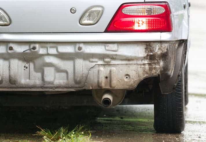 White car involved in car accident missing rear bumper