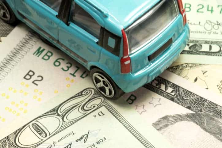 Is It Illegal To Drive Without Insurance? 1 Toy Car On Sitting On Money