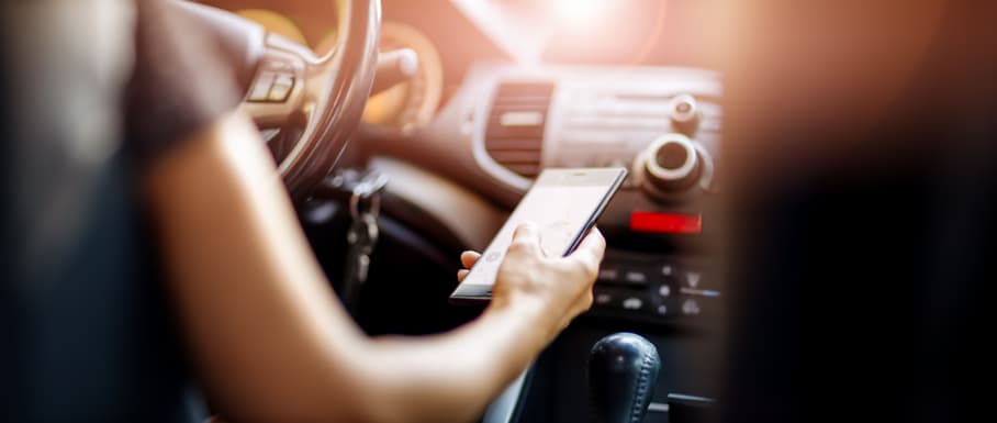 Woman texting while driving car