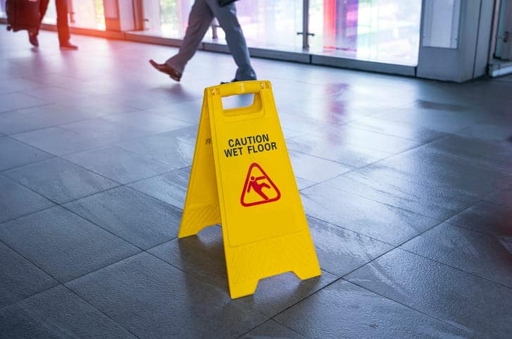 a yellow caution wet floor sign