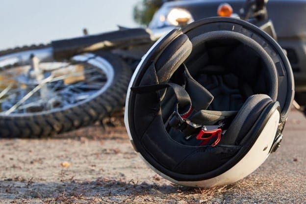 Motorcycle laying on ground at accident scene