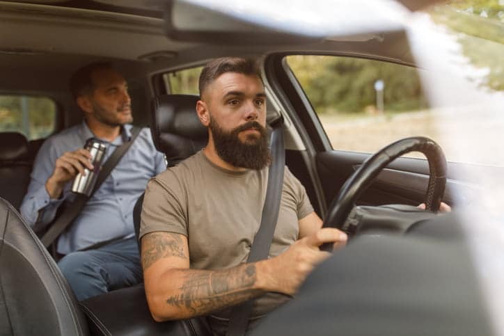 Ride Share Driver With Passenger In Back Seat