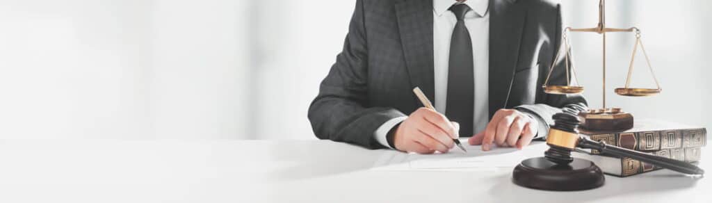 A Miami car crash lawyer sitting at his desk, filling out paperwork.