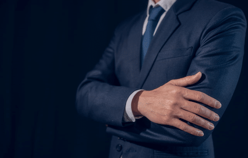 A car accident lawyer in Miami is posing with his arms crossed. The photo only shows his torso.