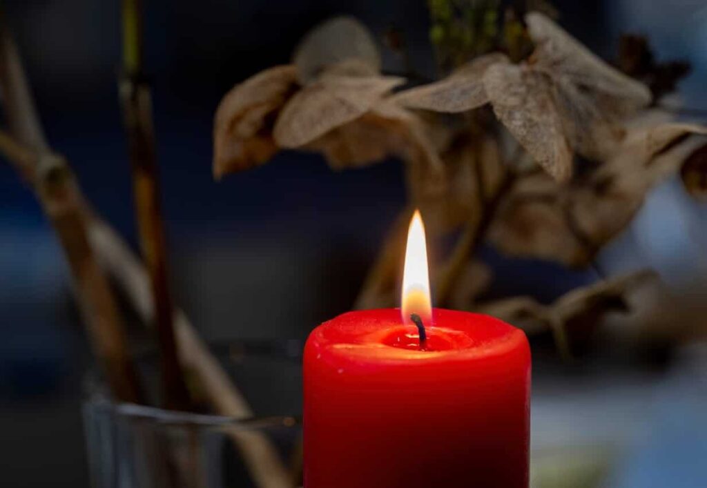 A red candle lit in memorial for a wrongful death in Miami, FL.