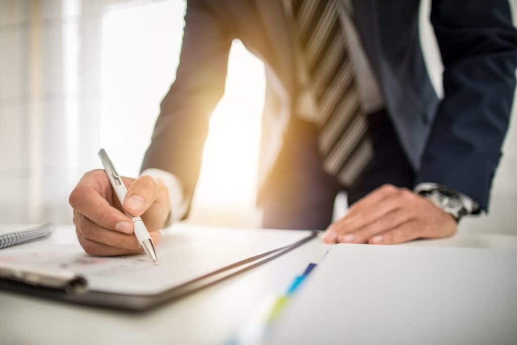 A Miami sexual assault lawyer working on paperwork at his desk.