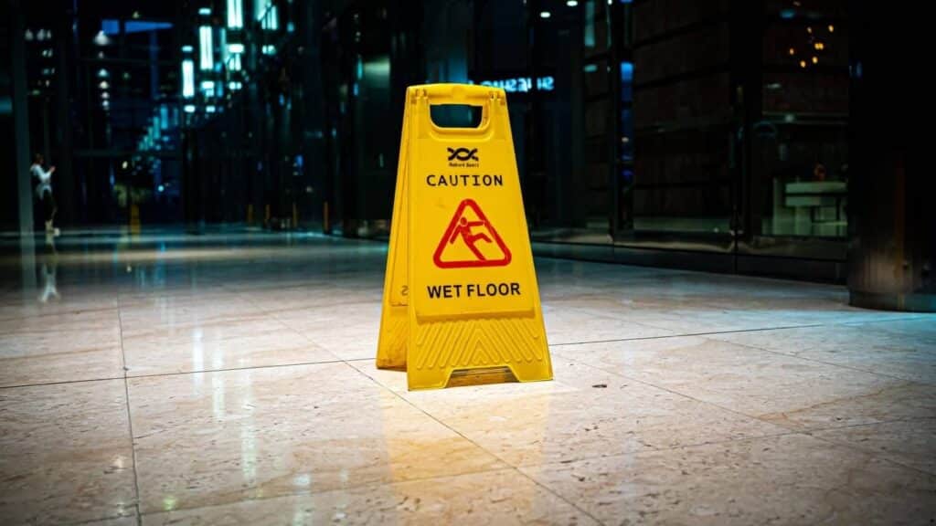 A caution wet slippery floor sign