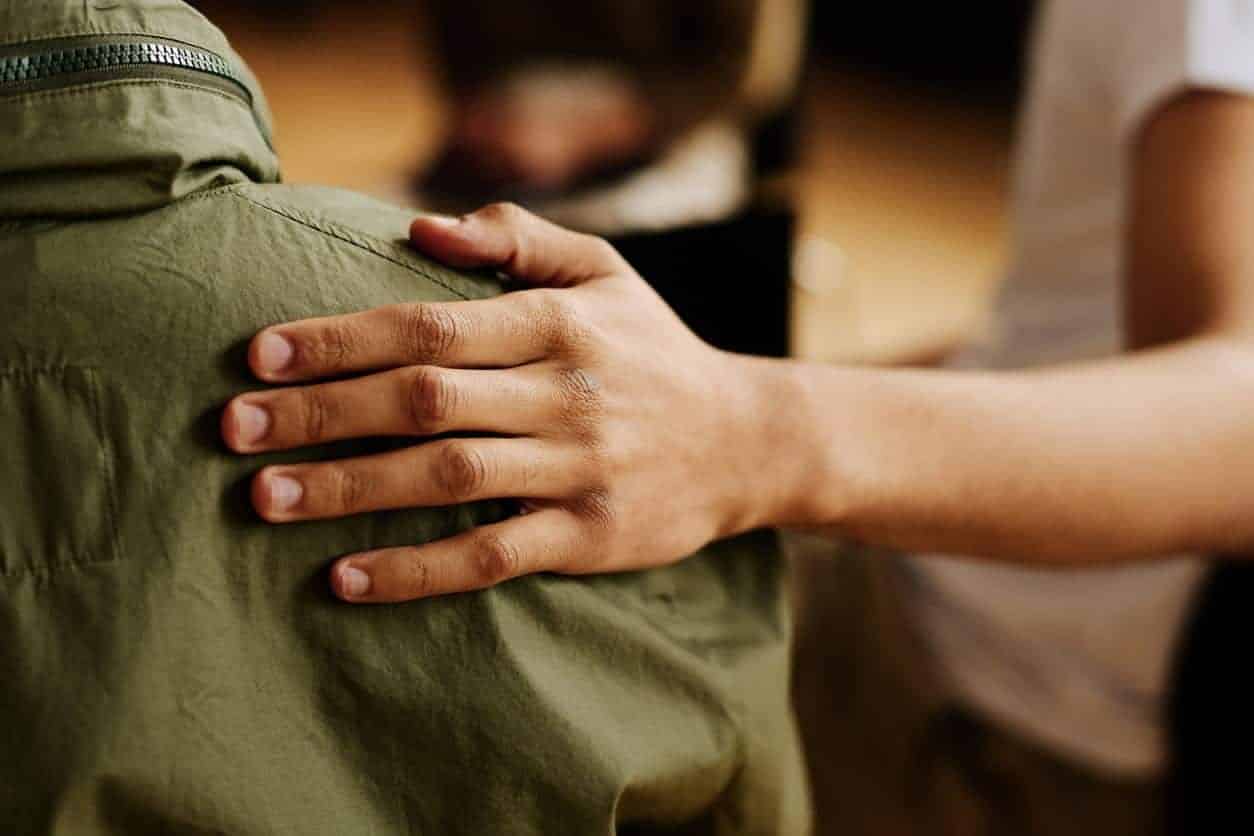 Someone Comforting A Sexual Assault Victim In A Group Meeting