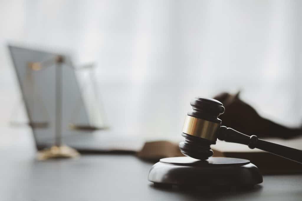 A gavel and the scales of justice on a drunk driving accident attorney's desk.