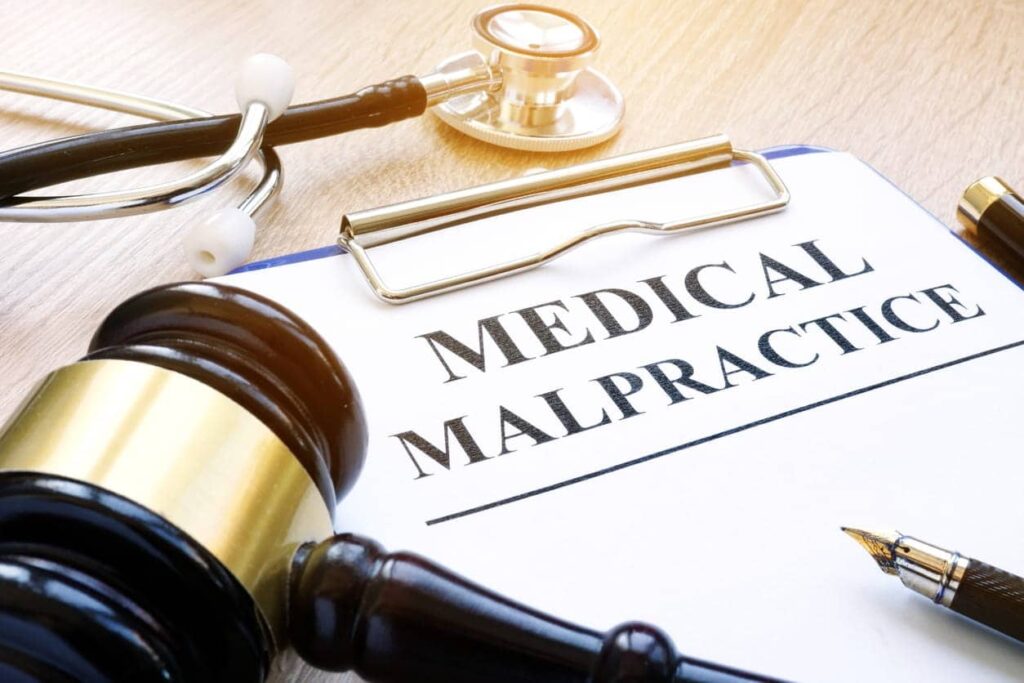 A clipboard with a paper that says medical malpractice