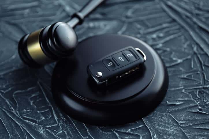 A car FOB sitting next to a gavel