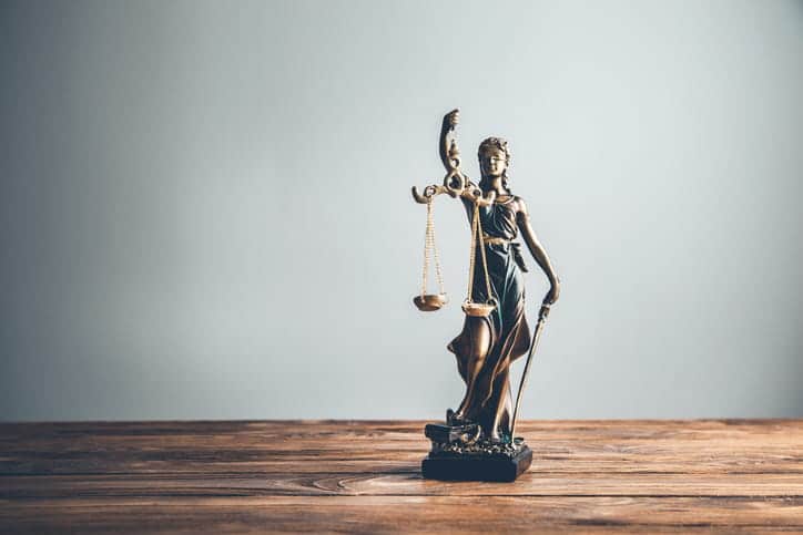 A Lady Justice Statue On A Personal Injury Attorney'S Desk. 