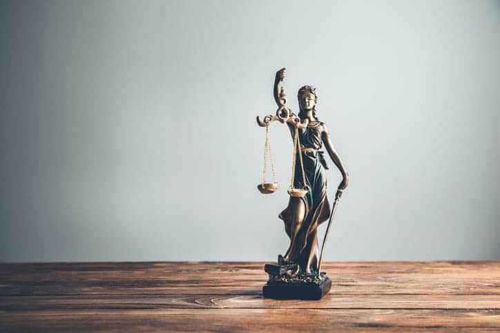 A Lady Justice statue on a personal injury attorney's desk. 