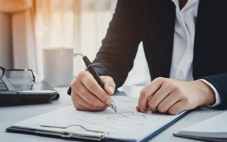 A personal injury attorney works on paperwork at his desk. 