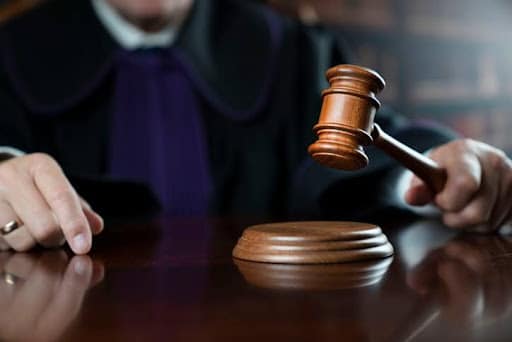 a judge holding wooden gavel