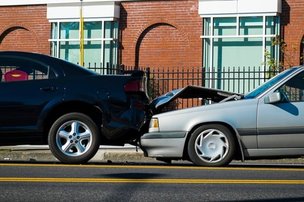 How Long Does A Rear-End Collision Settlement Take In Florida? 1 A Rear-End Collision Showing A Black Sedan Crashed Into The Back Of A Gray Car, With Visible Damage To Both Vehicles.