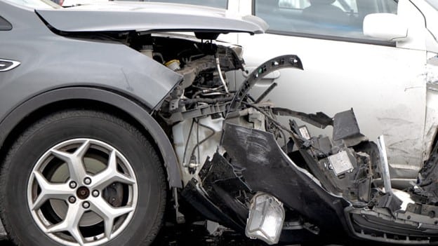 Severe T-Bone Collision At An Intersection Where A Gray Sedan Crashed Into The Side Of A White Suv, Causing Significant Damage To Both Vehicles.