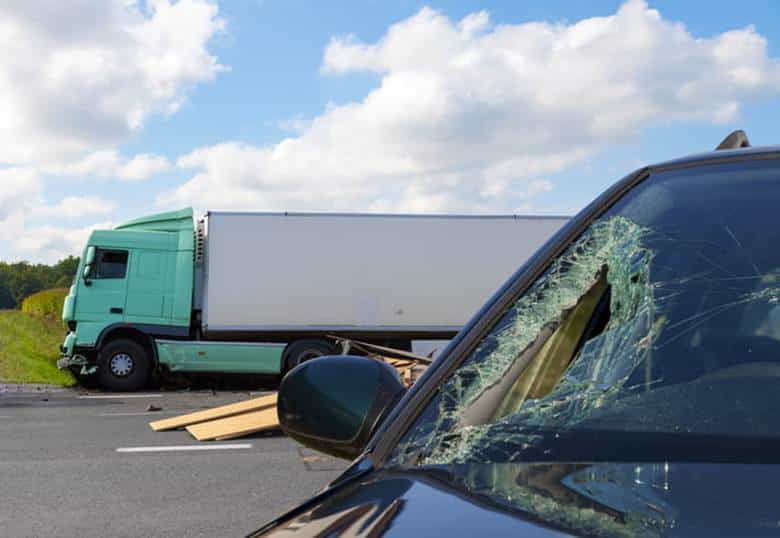 Highway Accidents 1 A Damaged Vehicle After Being In A Highway Accident With A Semi-Truck.