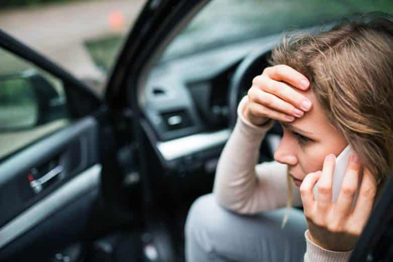 What Happens If You Leave The Scene Of A Car Accident? 2 A Woman Sitting In The Driver'S Seat Of Her Car, In Distress, While On The Phone After Being Involved In A Hit-And-Run Accident.