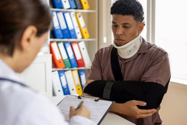 Kendall Personal Injury Lawyer 92 A Man In A Neck Brace And Arm Sling Speaks With A Personal Injury Attorney About His Case.
