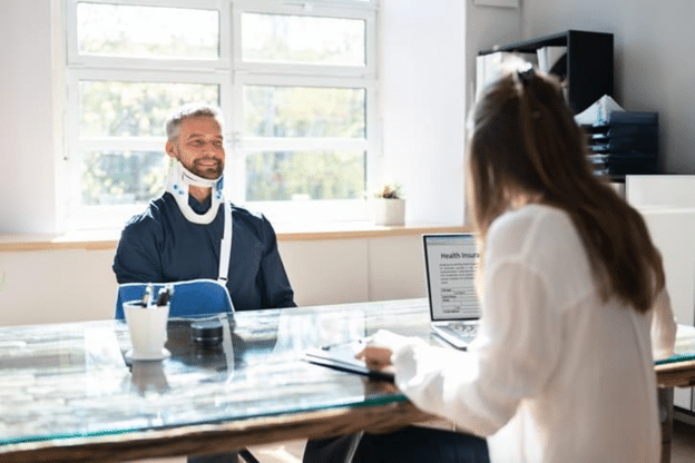 Weston Personal Injury Lawyer 2 A Man In An Arm Sling And A Neckbrace Speaks With His Personal Injury Attorney About His Accident.