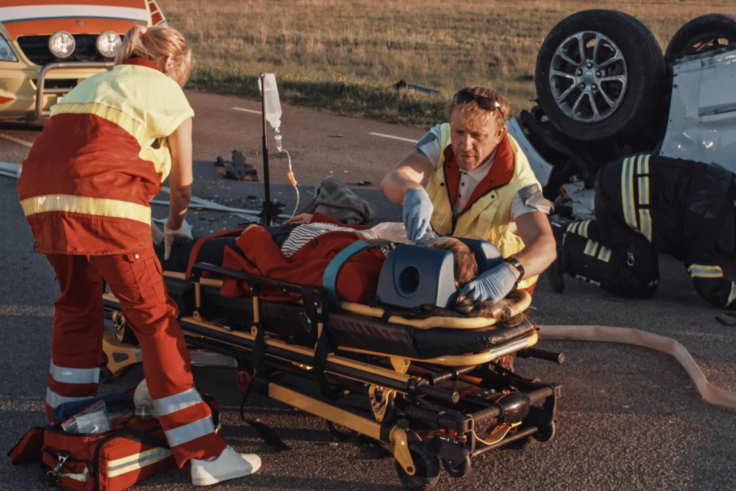Practice Areas 44 Severely injured car accident victim receiving emergency medical assistance after a catastrophic crash